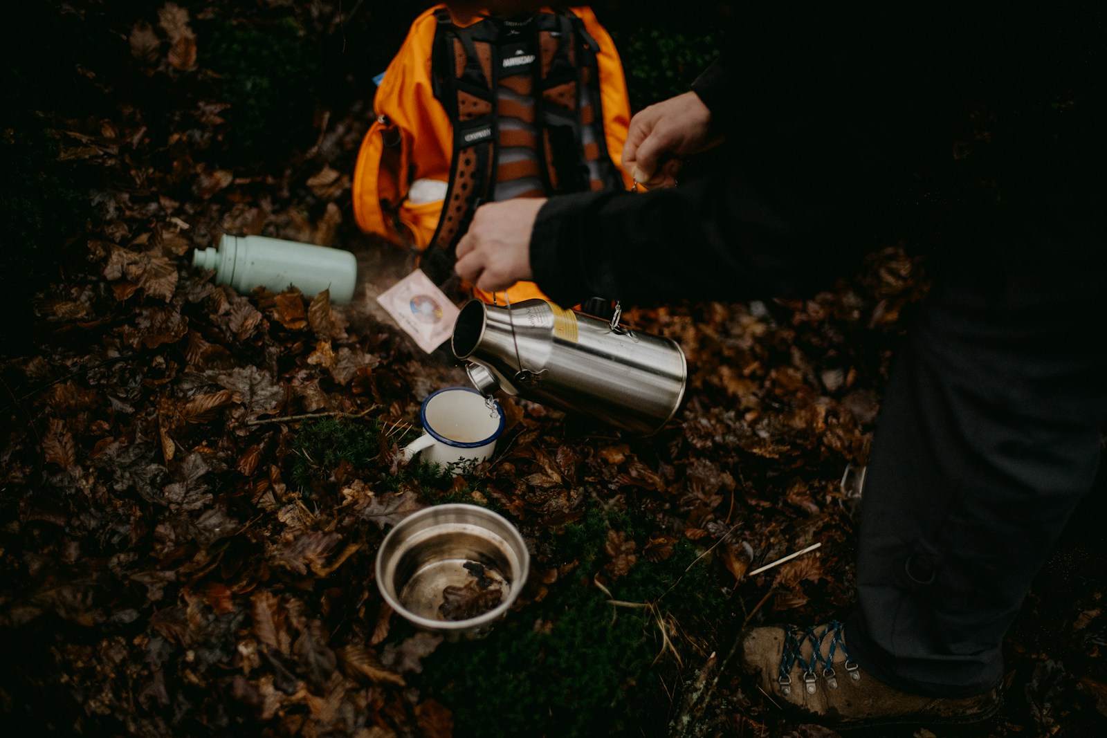 The Ultimate First-Time Camping Essentials: A Beginner’s Checklist a person pouring water into a cup on the ground