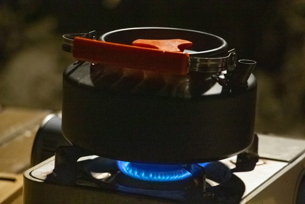 Best Titanium Camping Cookware: Is the Weight Savings Worth the Cost? A stove with a blue flame on top of it