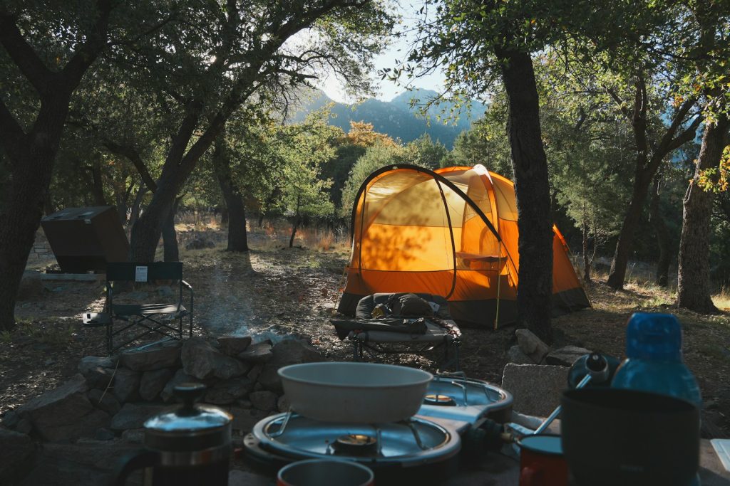 Camp Kitchen Organization: How to Store Food and Wash Dishes Like a Pro Camping and cooking amidst a scenic outdoor setting.