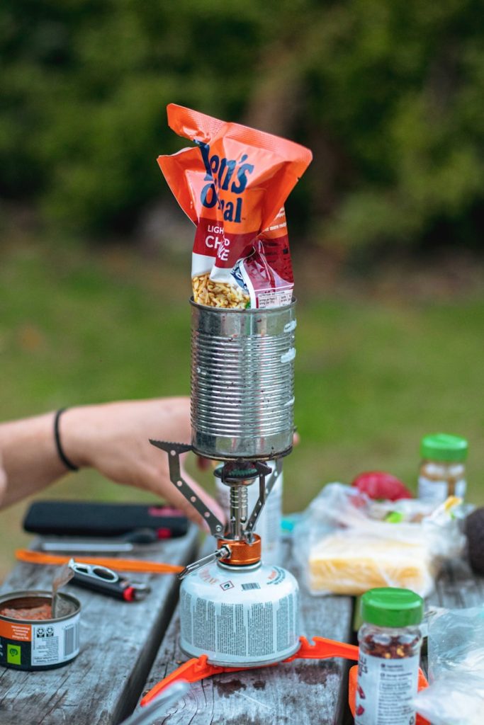 Camping Tips A person sitting at a picnic table with food