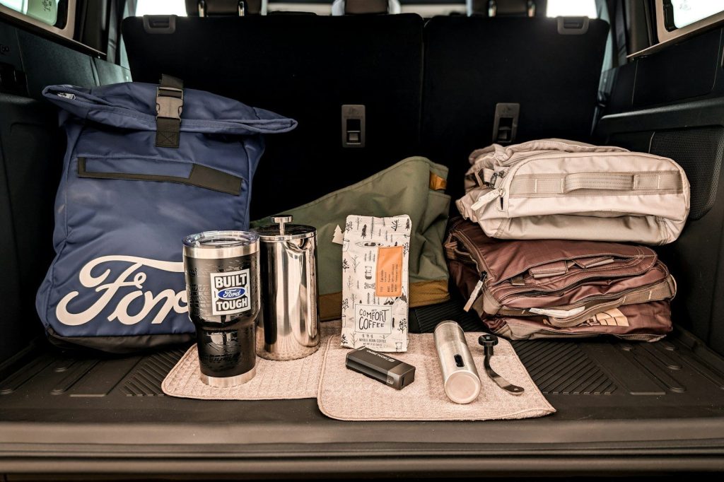 Essential First Aid Kit for Camping: Be Prepared for Anything Ford branded bag and travel accessories in car trunk