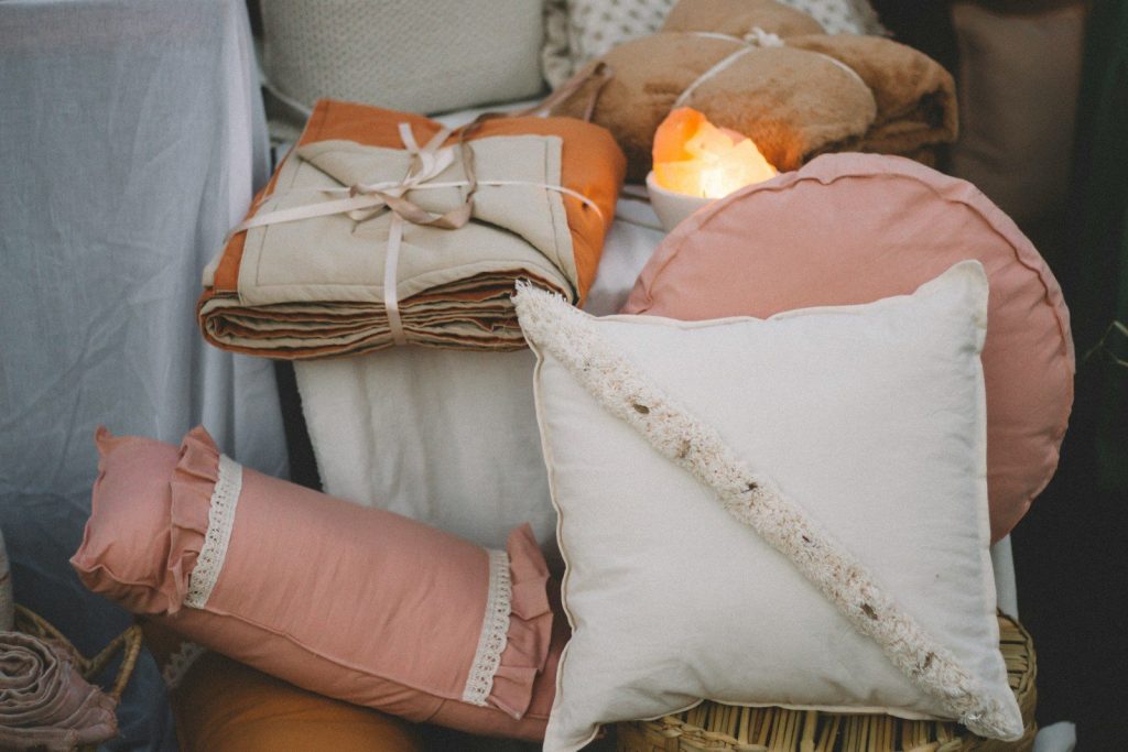 a pile of pillows and pillows sitting on top of a table