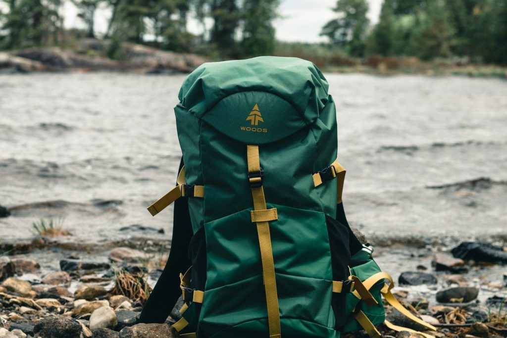 Best Backpacks with Ventilation: Vetted Anti-Sweat Trail Packs green and black backpack on brown wooden log