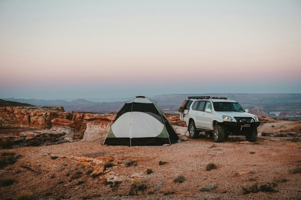 Car Camping vs Backpacking: The Ultimate Outdoor Dilemma white SUV beside tent