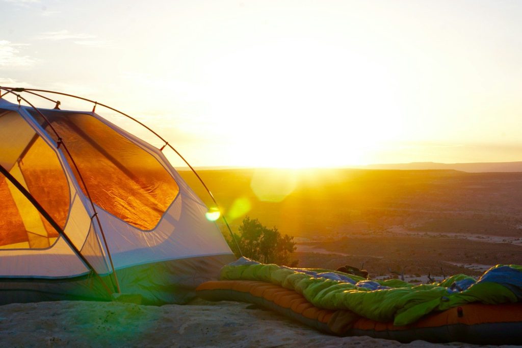 R-Value Explained: How Warm Should a Sleeping Pad Be? camping tent on cliff during golden hour