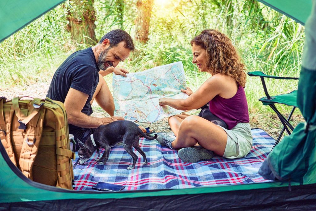 Emergency Camping Checklist: The Ultimate Failure-Proof Survival Gear Guide man in blue crew neck t-shirt and brown shorts sitting on blue and white textile